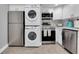 Updated kitchen featuring stainless steel appliances and stackable washer/dryer at 9000 Commodore Dr # 401, Seminole, FL 33776