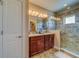 Elegant bathroom with double vanity and large walk-in shower at 94 The Cove Way, Indian Rocks Beach, FL 33785