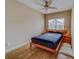 Cozy bedroom with wood floors and a ceiling fan at 94 The Cove Way, Indian Rocks Beach, FL 33785