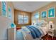 Comfortable bedroom features a white bed frame, nautical themed accents, and plenty of natural light at 94 The Cove Way, Indian Rocks Beach, FL 33785