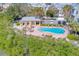 Community pool with a pergola and lounge chairs at 94 The Cove Way, Indian Rocks Beach, FL 33785