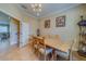 Dining room with light wood table, six chairs, and decorative shelving at 94 The Cove Way, Indian Rocks Beach, FL 33785