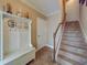 Inviting entryway with tiled floor, white bench, and coat hooks at 94 The Cove Way, Indian Rocks Beach, FL 33785