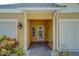 Inviting entryway with a charming front door and walkway at 94 The Cove Way, Indian Rocks Beach, FL 33785