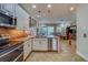 Modern kitchen with island, stainless steel appliances and granite countertops at 94 The Cove Way, Indian Rocks Beach, FL 33785