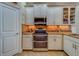 Modern kitchen featuring stainless steel appliances and granite countertops at 94 The Cove Way, Indian Rocks Beach, FL 33785