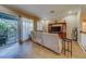 Spacious living room with tiled floors, beige couch, and built-in entertainment center at 94 The Cove Way, Indian Rocks Beach, FL 33785