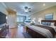 Spacious main bedroom featuring a king bed, lounge area, wood floors and an abundance of natural light at 94 The Cove Way, Indian Rocks Beach, FL 33785