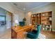 Home office with wood desk, chair, floor to ceiling bookshelves, and lots of natural light at 94 The Cove Way, Indian Rocks Beach, FL 33785