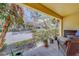 Relaxing patio with wicker furniture and view of landscaping at 94 The Cove Way, Indian Rocks Beach, FL 33785