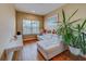 Bright sitting room with large window and comfortable seating at 94 The Cove Way, Indian Rocks Beach, FL 33785