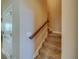 Staircase with wood railing and tile flooring at 94 The Cove Way, Indian Rocks Beach, FL 33785