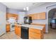 Kitchen with island, wood cabinets, and stainless steel appliances at 2102 Deltona Blvd, Spring Hill, FL 34606