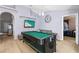 Game room with a pool table, flat-screen TV, and seating area at 2102 Deltona Blvd, Spring Hill, FL 34606