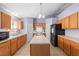 Kitchen with island, wood cabinets, and stainless steel appliances at 2102 Deltona Blvd, Spring Hill, FL 34606