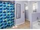 Bathroom with shower/tub combo, geometric shower curtain, and tiled floor at 2102 Deltona Blvd, Spring Hill, FL 34606