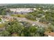 Aerial view of neighborhood, including a school and residential area, highlighting the community's amenities at 2102 Deltona Blvd, Spring Hill, FL 34606