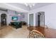 Dining area with a wooden table, chairs, and a view of the game room at 2102 Deltona Blvd, Spring Hill, FL 34606