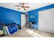 Blue bedroom with a bed, desk, and large closet at 2102 Deltona Blvd, Spring Hill, FL 34606
