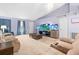 Living room with vaulted ceiling, sofas, and large TV at 2102 Deltona Blvd, Spring Hill, FL 34606