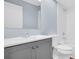 Modern bathroom featuring a gray vanity, white sink, toilet, bathtub and shower at 3499 Cedar Ln, Palm Harbor, FL 34684