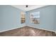 Comfortable bedroom with neutral tones, hardwood floors, and ample natural light from two windows at 3499 Cedar Ln, Palm Harbor, FL 34684