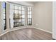 Bright breakfast nook featuring a large bay window and wood-look flooring at 3499 Cedar Ln, Palm Harbor, FL 34684