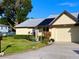 Charming one-story home with well-maintained lawn and landscaping and a two-car garage at 3499 Cedar Ln, Palm Harbor, FL 34684