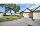 Charming one-story home with well-maintained lawn and landscaping and a two-car garage at 3499 Cedar Ln, Palm Harbor, FL 34684