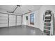 Spacious two car garage with white door, painted floor and storage shelving at 3499 Cedar Ln, Palm Harbor, FL 34684