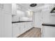 Modern kitchen with white cabinets and granite countertops at 3499 Cedar Ln, Palm Harbor, FL 34684