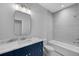 Clean bathroom with navy vanity and bathtub at 3612 W Renellie Cir, Tampa, FL 33629