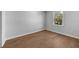 Bright bedroom with hardwood floors and large window at 3612 W Renellie Cir, Tampa, FL 33629
