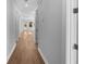 Light hardwood floors and neutral walls in a home hallway at 3612 W Renellie Cir, Tampa, FL 33629