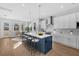Modern kitchen featuring white cabinetry, a blue island, and stainless steel appliances at 3612 W Renellie Cir, Tampa, FL 33629