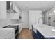 Modern kitchen with white cabinets, blue island, and stainless steel appliances at 3612 W Renellie Cir, Tampa, FL 33629