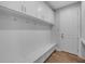 Laundry room with white cabinets and built-in bench at 3612 W Renellie Cir, Tampa, FL 33629