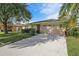 Single-story house with attached garage and landscaped lawn at 4175 103Rd N Ave, Clearwater, FL 33762
