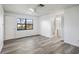 Bedroom with wood-look floors and access to bathroom at 4175 103Rd N Ave, Clearwater, FL 33762