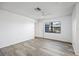 Spacious bedroom with wood-look floors and backyard view at 4175 103Rd N Ave, Clearwater, FL 33762