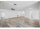 Open-concept living room with wood-look flooring and neutral walls at 4175 103Rd N Ave, Clearwater, FL 33762