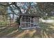 Rustic chicken coop nestled under large shade trees at 6411 Barton Rd, Plant City, FL 33565