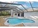 Large kidney shaped pool with screened enclosure at 6411 Barton Rd, Plant City, FL 33565