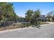 Street view of residential properties with chain link fence, driveway, covered parking on a sunny day at 7060 Boca Ciega Dr, St Pete Beach, FL 33706