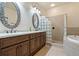 Bright bathroom featuring a double vanity, glass block shower, and soaking tub at 790 7Th Ne Ave, Largo, FL 33770