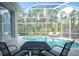 Relaxing screened pool area with patio furniture and lush landscaping at 11401 Georgetown Cir, Tampa, FL 33635