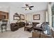 Gathering room with leather furniture, ceiling fan, and wood coffee table at 11401 Georgetown Cir, Tampa, FL 33635