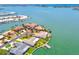 Expansive aerial view showcasing waterfront homes, lush landscaping, private docks, and tranquil turquoise waters at 11683 Grove St, Seminole, FL 33772
