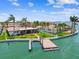 Aerial view of a waterfront home and private dock on a clear and sunny day at 11683 Grove St, Seminole, FL 33772