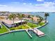 Stunning aerial view of waterfront homes with manicured lawns, boat lifts, and serene water views at 11683 Grove St, Seminole, FL 33772